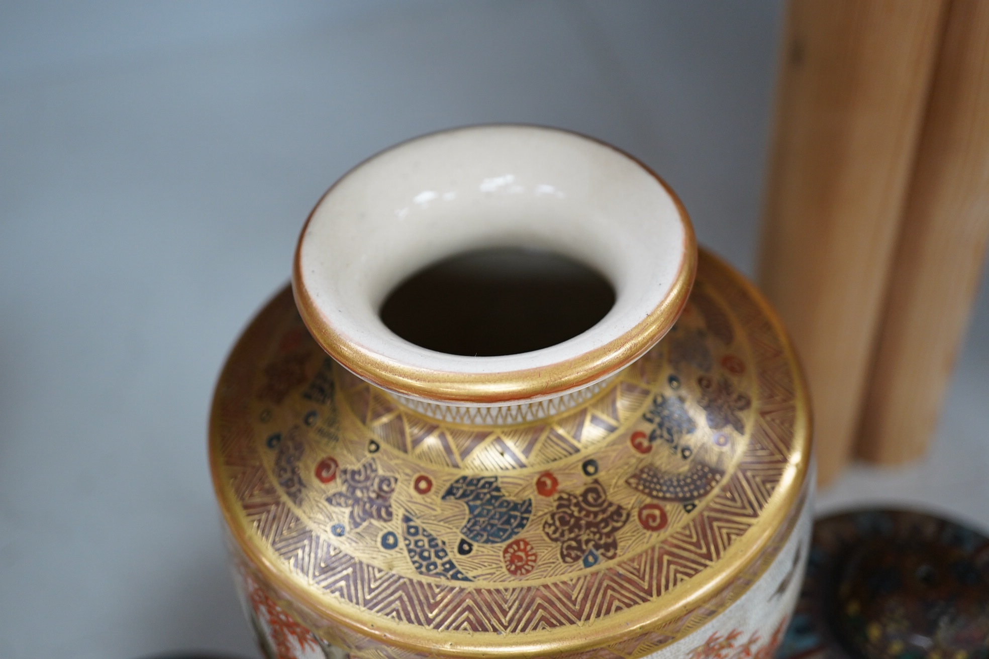 A pair of Japanese cloisonné enamel jars and covers, a Japanese bronze and gold overlaid small vase and a Satsuma pottery vase, tallest 22cm high (4). Condition - finial loose and one missing on cloisonné jars and covers